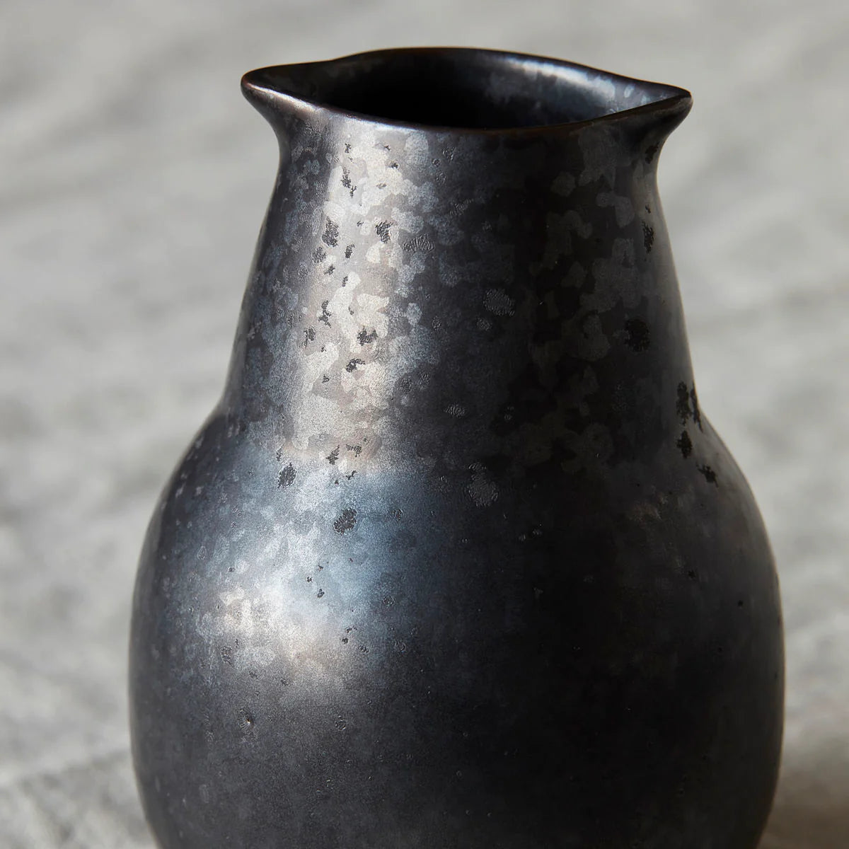 Close up of texture of Black ceramic vase Wabi Sabi style pourer jug