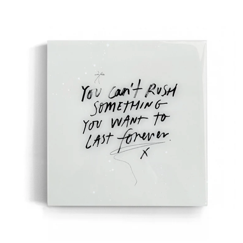 White square quote wall art tile with black text on a white background