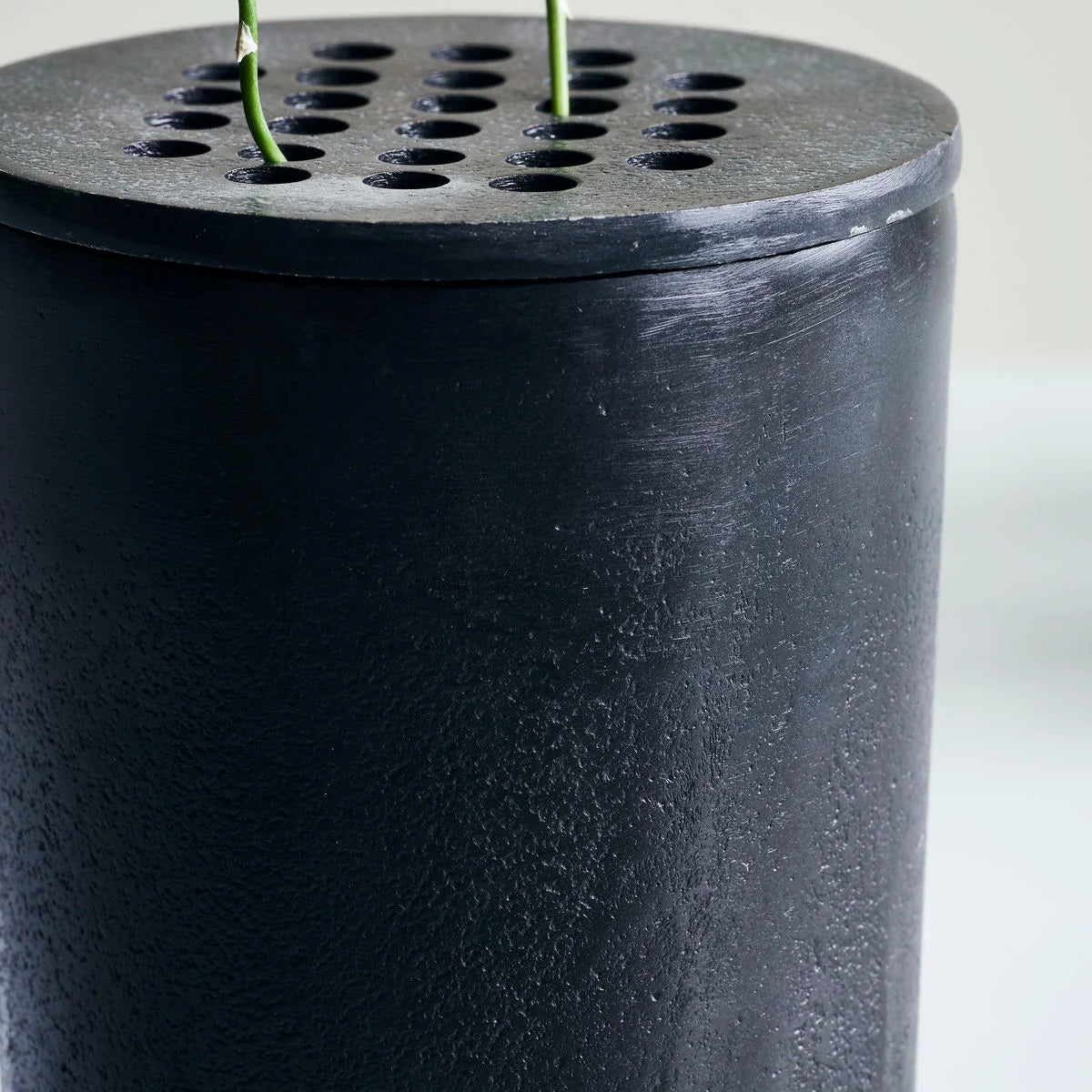 close up of black metal vase Wabi Sabi style