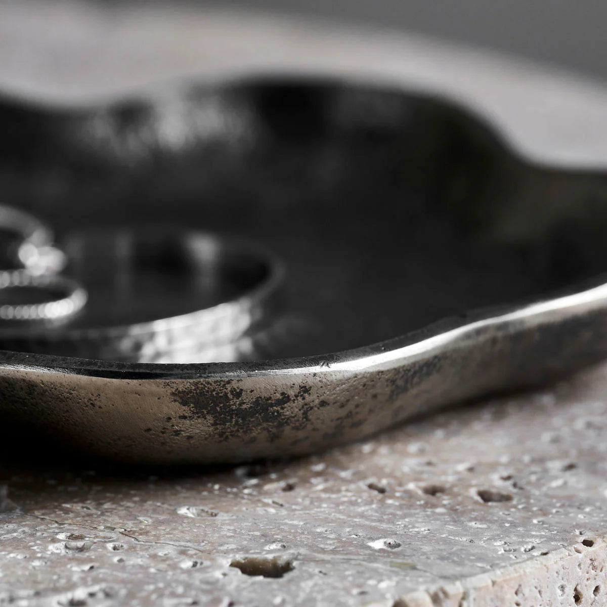 Close-up of a textured metal object on a rough surface