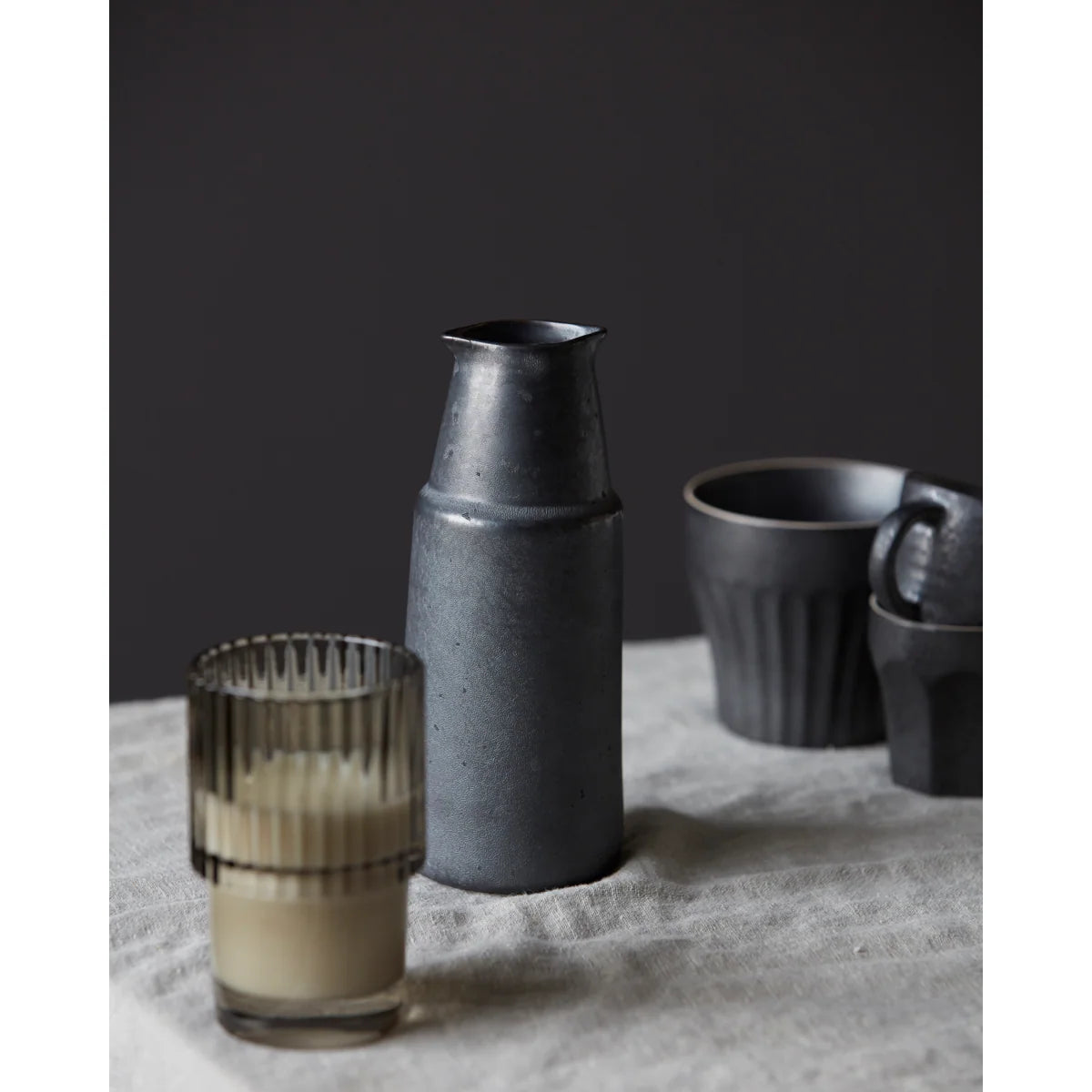 Dark gray ceramic vase Wabi Sabi style styled with other homewares